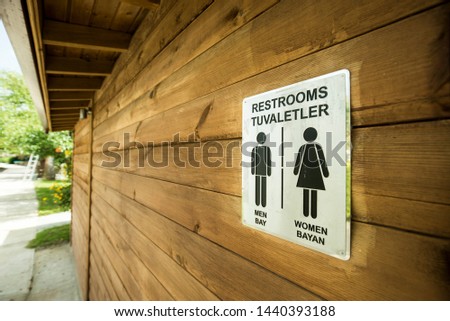 Restroom Sign on The wooden Wall