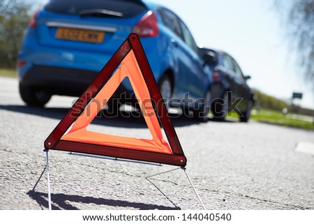 Warning Triangle By Two Cars Involved In Accident