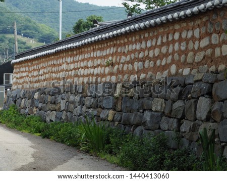 Korean traditional wall with tiled roof, made by clay and stones