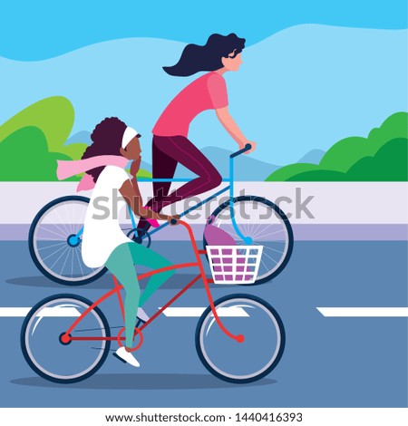 young women riding bike in the road