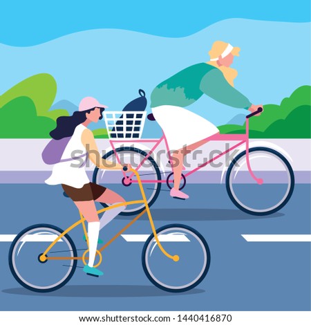 young women riding bike in the road