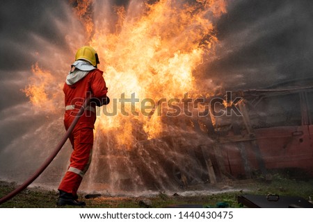  firefighters spraying water in fire fighting operation,Fire and rescue training school regularly