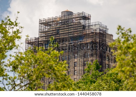 Building under construction with scaffolding in New York Manhattan