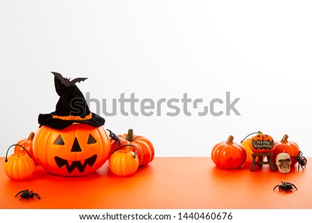 Happy Halloween pumpkin with festive decorations floor orange on white wall background. Empty space for the text design