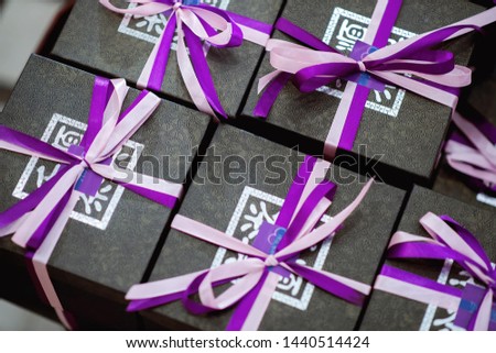 Gift box black purple ribbon Royalty-Free Stock Photo #1440514424