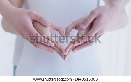 Couple making a heart shape with hands. Royalty-Free Stock Photo #1440515303