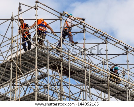 construction worker on a scaffold, symbolfoto for building, construction boom, labor protection Royalty-Free Stock Photo #144052165