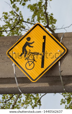 Warning sign for bicycle riders going over tram tracks.