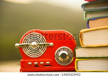 Many books are on beautiful green lawns. With beautiful red speakers in the picture Suitable for educational use