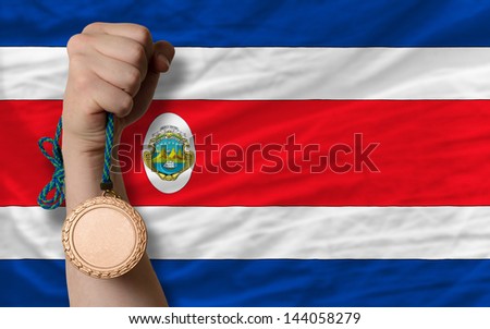 Holding bronze medal for sport and national flag of columbia