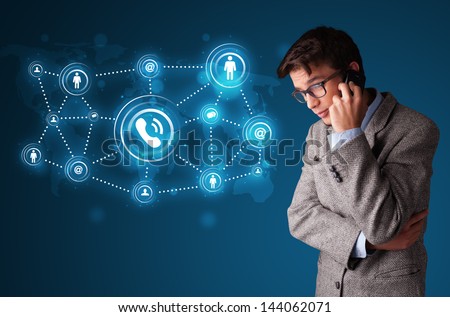 Young boy standing and making phone call with social network icons