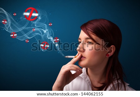 Beautiful young woman smoking dangerous cigarette with no smoking signs