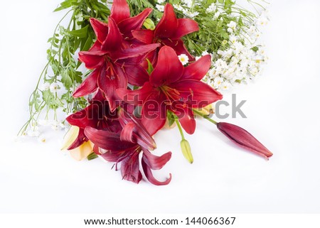 Field bouquet from a lily and camomiles