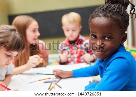African girl in the Kita or international kindergarten drawing course
