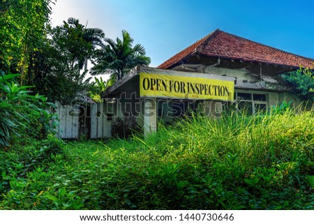 Open for Inspection Sign Banner in Front of Empty Damage Abandoned House Building with Unattended Garden Full of Grass and Weed Before Being Demolished For New Real Estate Commercial Development