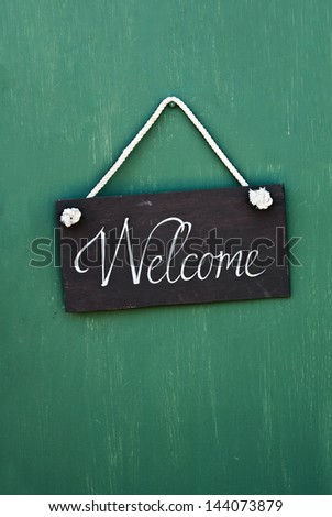 blackboard with the words welcome to hang on the door