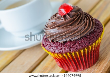 Chocolate cupcake with white cup tea