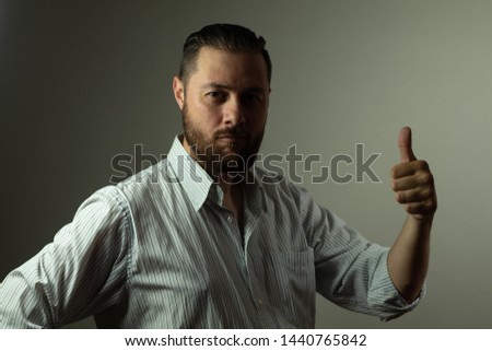 Casual business man. Beard guy in shirt. Business success concept. Thumbs up and looking at a light bulb idea