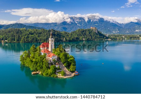 Lake Bled, Slovenia - Beautiful aerial view of Lake Bled (Blejsko Jezero) with the Pilgrimage Church of the Assumption of Maria on a small island and Bled Castle and Julian Alps at backgroud at summer Royalty-Free Stock Photo #1440784712