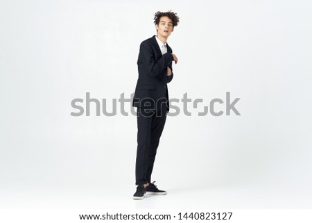 curly hair young guy suit light background business                    