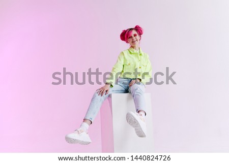 woman with pink hair hairstyle sits on a cube retro style