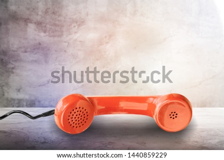 Orange handset on the table
    
    - Image