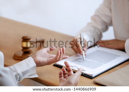 Justice lawyer consulting give a advice with client in courtroom. 