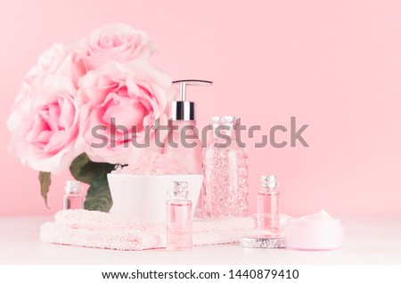 Luxury bathroom interior in romantic style - soft pink roses, cosmetic products for skin, body care, accessories on pastel pink, white background.