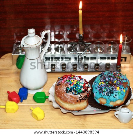 Beautiful multicolored Hanukkah donuts. Pastry decoration on donuts. Chanukia, Sevivon, Dreidl.