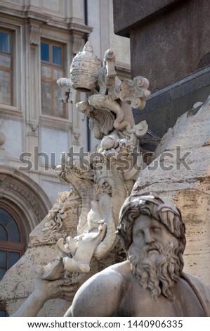 A detail of the statue of the River Ganges on the baroque Fountain of the Four Rivers in Piazza Navona in Rome. Behind the statue is the papal coat of arms of the Pamphilli popes.
