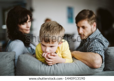 helpless parents and their badly behaving son at home Royalty-Free Stock Photo #1440913190