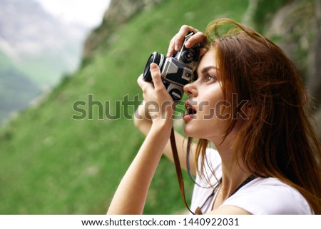 woman takes pictures of nature mountain