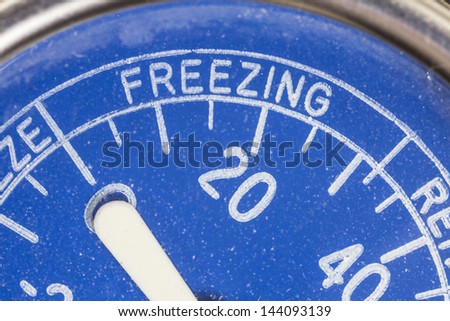 Vintage refrigerator thermometer freezing zone macro detail Royalty-Free Stock Photo #144093139