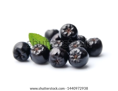 Black chokeberry isolated on white backgrounds. Black aronia berries. Royalty-Free Stock Photo #1440972938