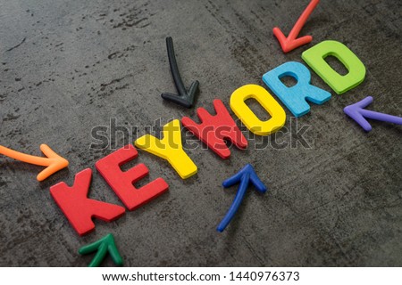 Keywords research for SEO, Search Engine Optimization, bidding on search result page to promote website online, multi color arrows pointing to the word Keyword at the center of black chalkboard wall. Royalty-Free Stock Photo #1440976373