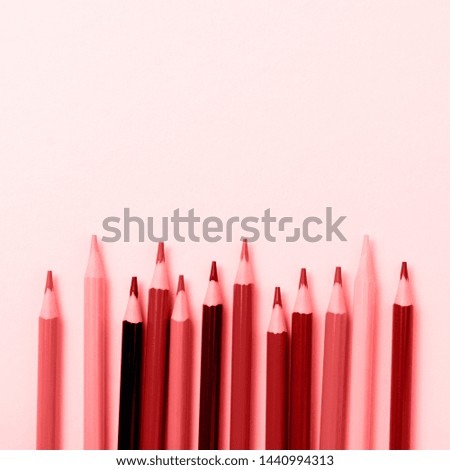 Wooden pencils for school on yellow paper background. School and office stationery on yellow background. Trendy living coral color of year 2019. Concept back to school. Square image. Top view.
