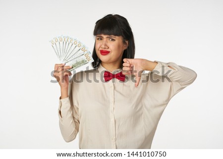 woman in white shirt holding money in her hands                               