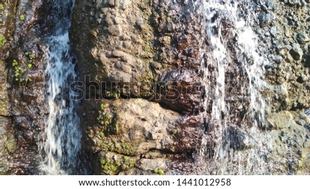 the flow of river water in the rocks of the mountains