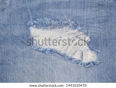 Blue jeans torn denim texture use for background


