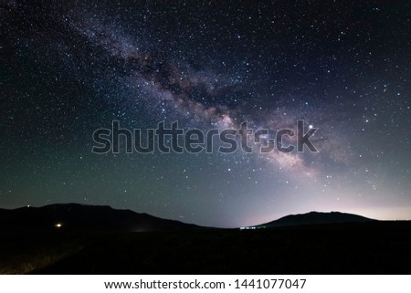 Beautiful starry night. Bright milky way galaxy over the hills.