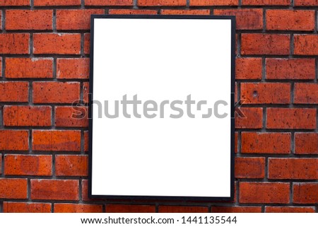 black metal photo frame on orange brick wall
