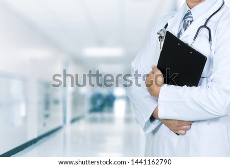 Doctor with black clipboard and stethoscope on medical background