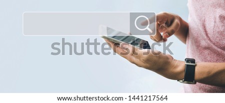 Searching and big data concepts with male hand using smart phone with search engine icon sign.Business information.global network system.minimal photo
