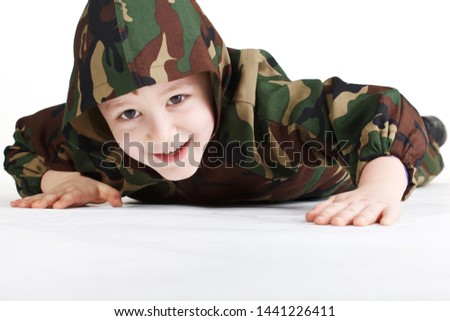 The little boy in a military uniform. On a white background.