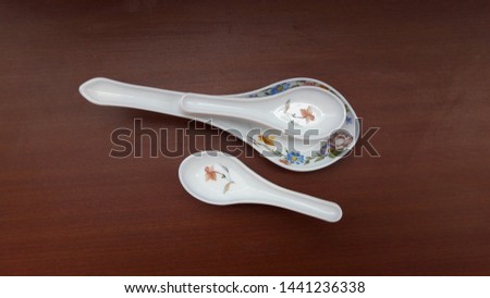 crockery spoons isolated on brown background