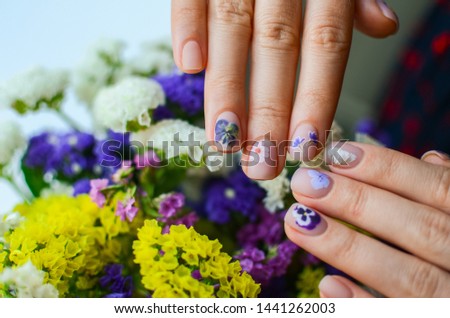 perfect nails design with botanical pattern. Females hands with manicure. Plant concept in nails art. summer dry flowers.