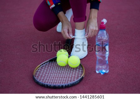 black sneakers tennis racket sport water bottle