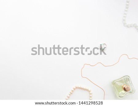 perfume and jewelry on white background