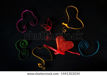 World Kindness day thirteenth of November - different colors hearts that made the children are on a black table