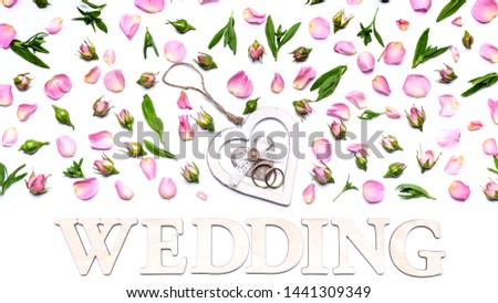 Flower pattern on a white background. Petals and buds of roses. In the center is a stand for rings in the shape of a heart. Word Wedding